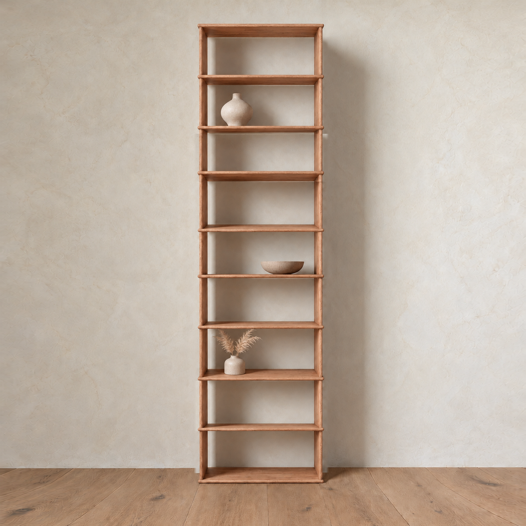 The 1 column 10 foot tall bookcase in red oak styled with a ceramic vase, a bowl and dried grass.