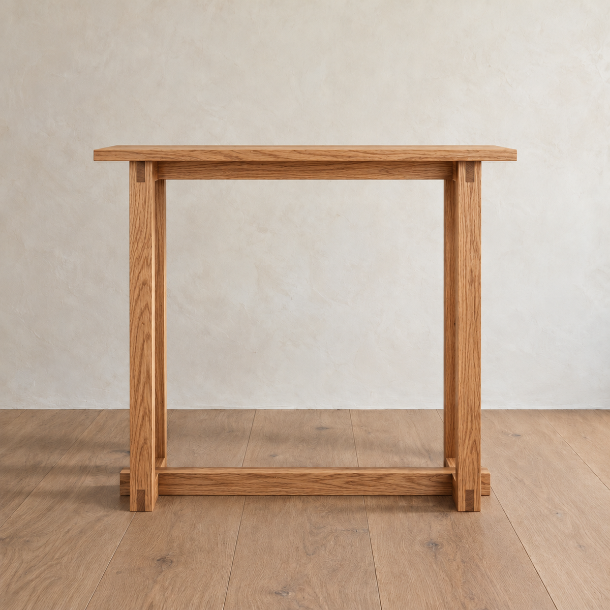 Front view of the 2 person bar table in red oak against a plaster wall, showing the stretcher under the top and the one near the floor.