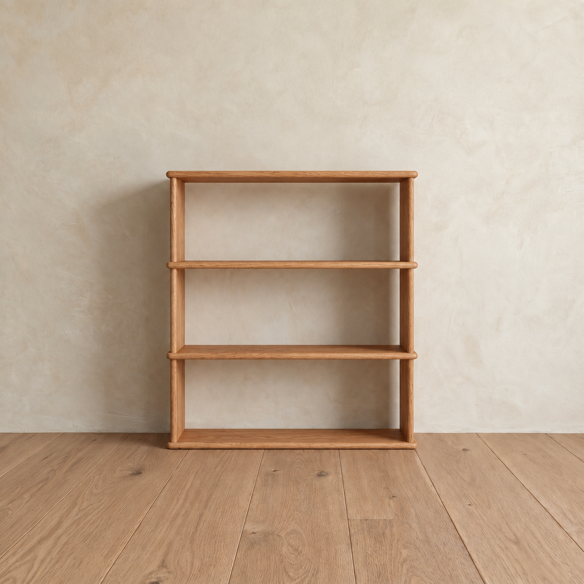Front view of the empty 3 shelf bookcase in red oak, showing its open back and softly rounded shelf edges.