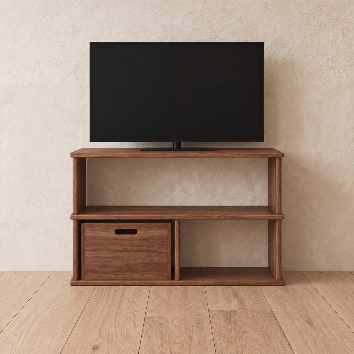 The 40 inch bookshelf TV stand in walnut holding a flat-screen TV, with a wooden storage cube in the lower left opening, against a plaster wall.