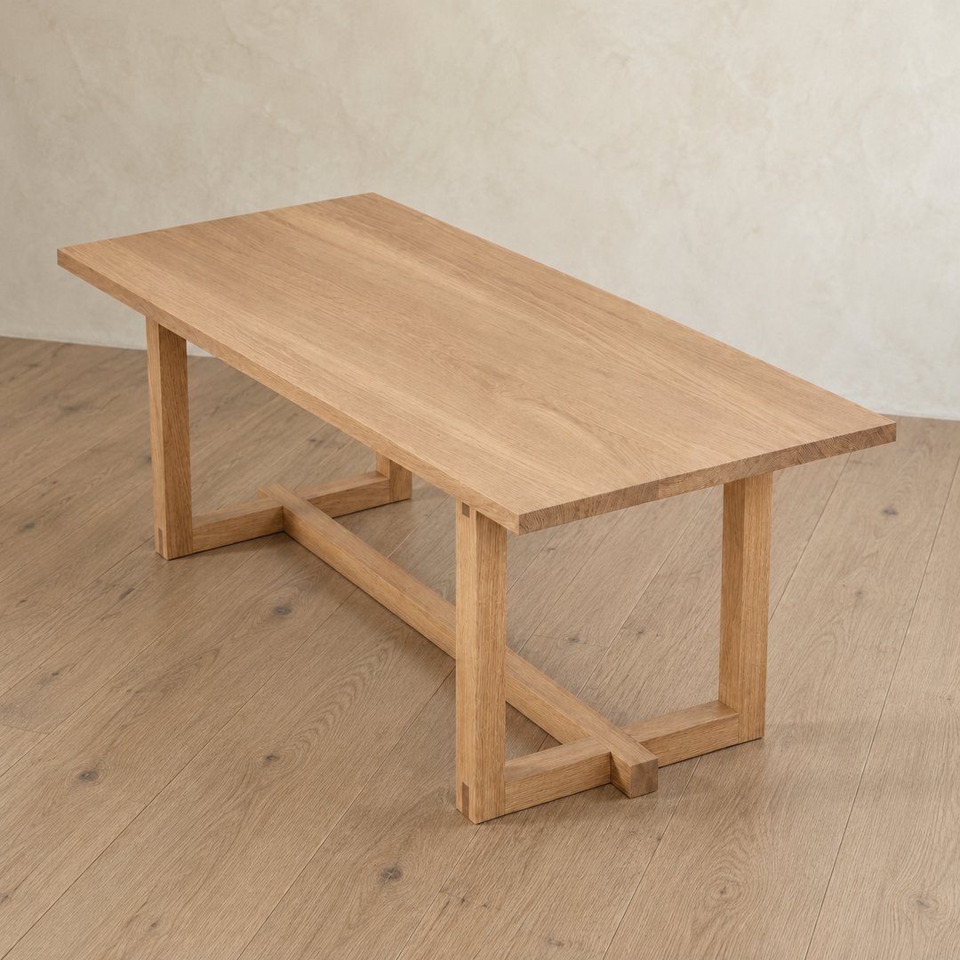 Handcrafted 6 person dining table in white oak with a rectangular top and trestle base.