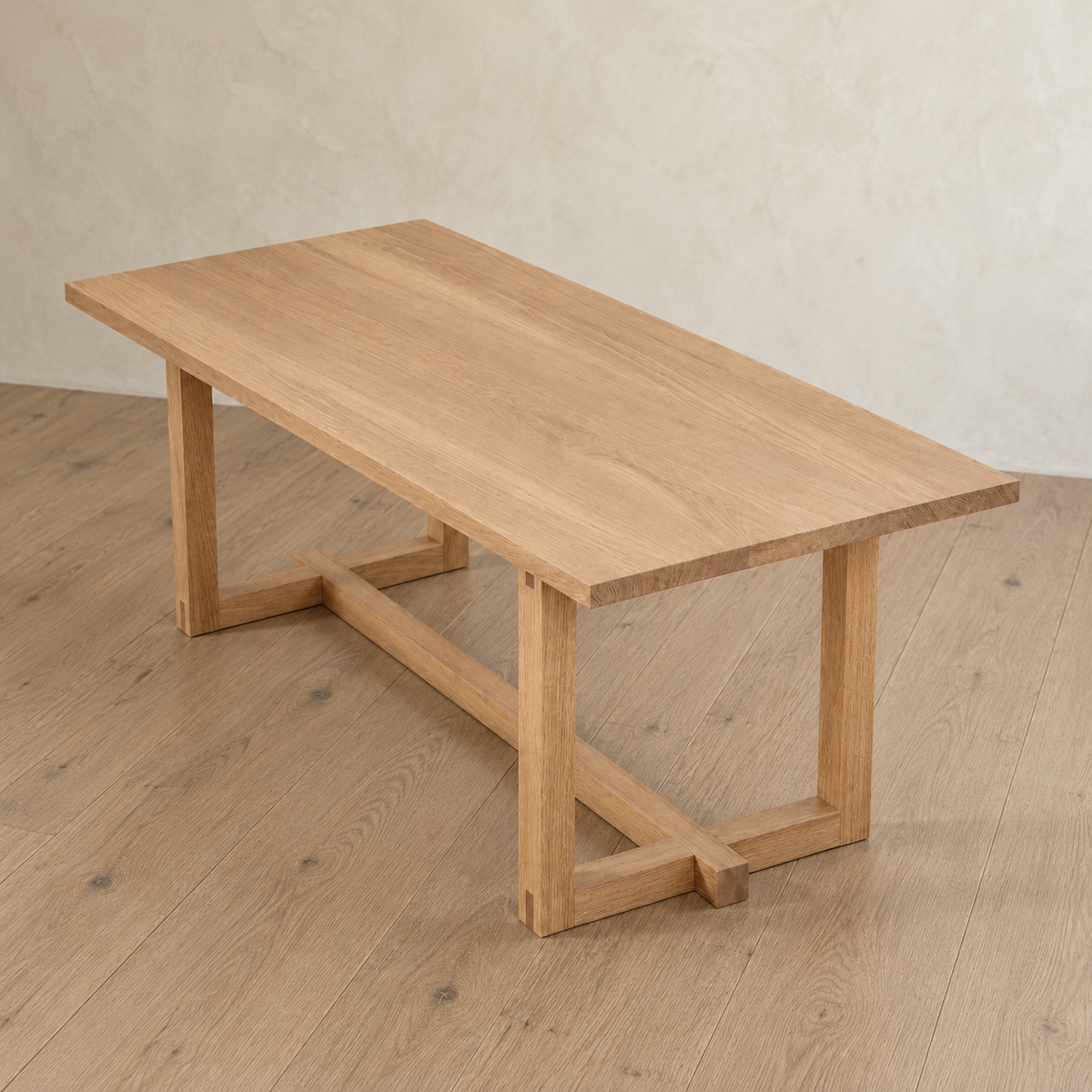Handcrafted 6 person dining table in white oak with a rectangular top and trestle base.