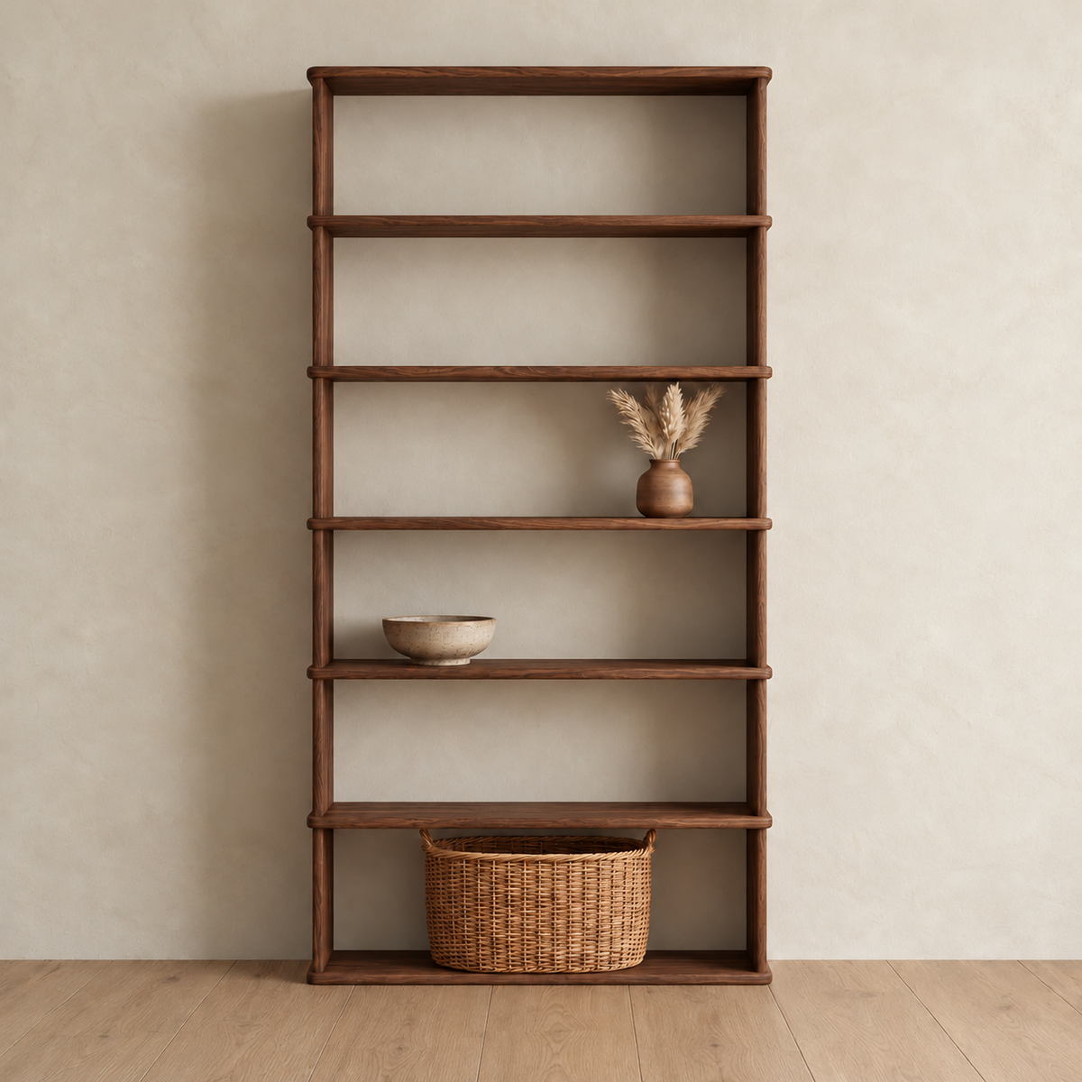 The 6 shelf bookcase in walnut against a plaster wall, with a vase of dried grass, a ceramic bowl and a woven basket on its shelves.