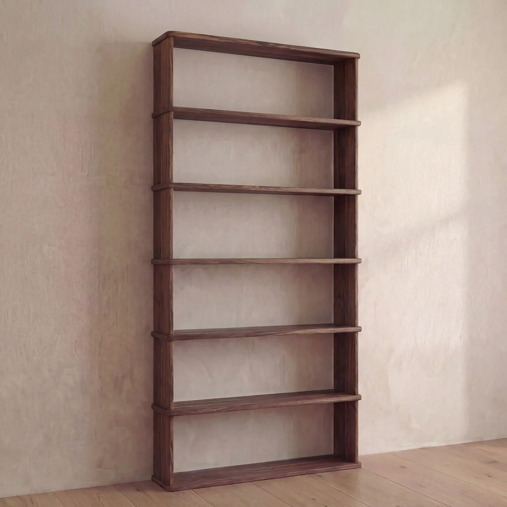 A 6 shelf bookcase in walnut stands empty against a pale wall on a wooden floor in a minimalist room.