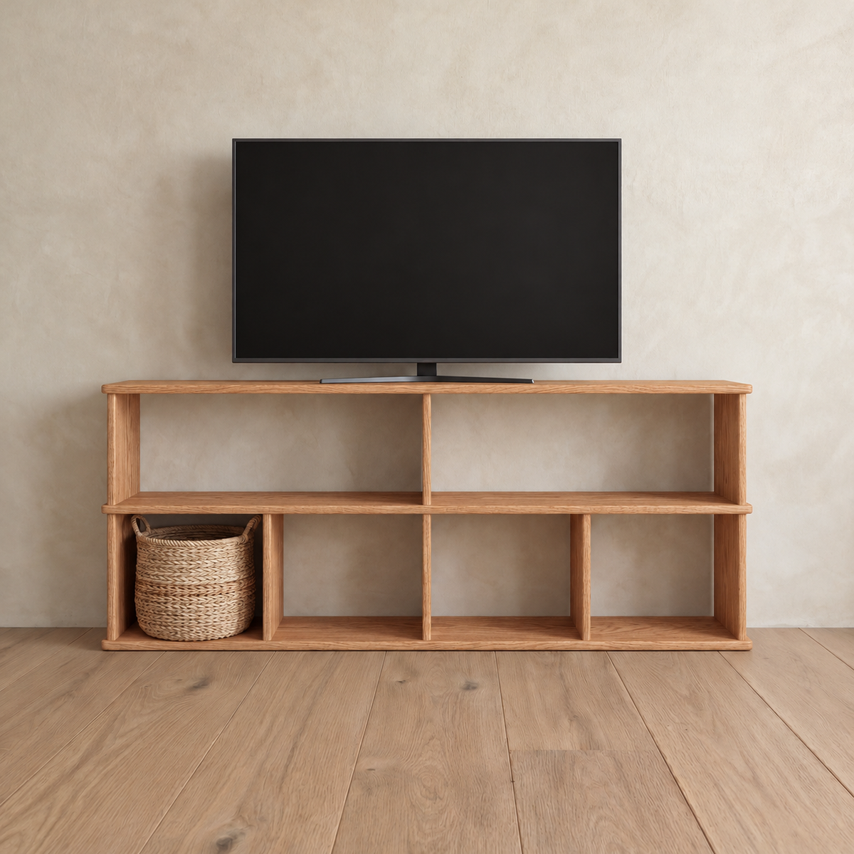 The 65 inch bookshelf TV stand in red oak holding a flat-screen TV, with a woven basket in one of the lower compartments.