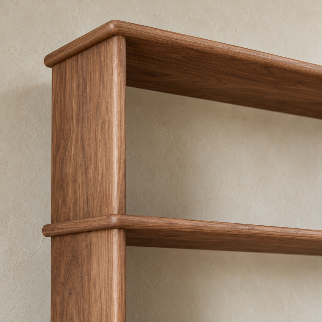 Close-up of a softly rounded shelf edge meeting the side of the 7 foot tall bookcase in walnut.