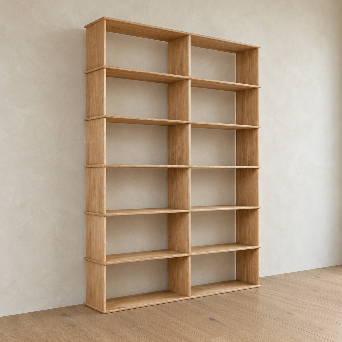 The 2 column 7 foot tall bookcase in white oak from an angle against a plaster wall.