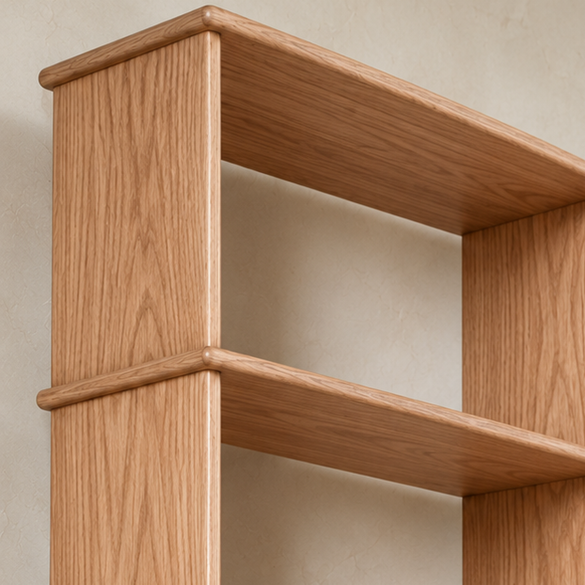 Close-up of a softly rounded shelf edge meeting the side of the 8 foot tall bookcase in red oak.