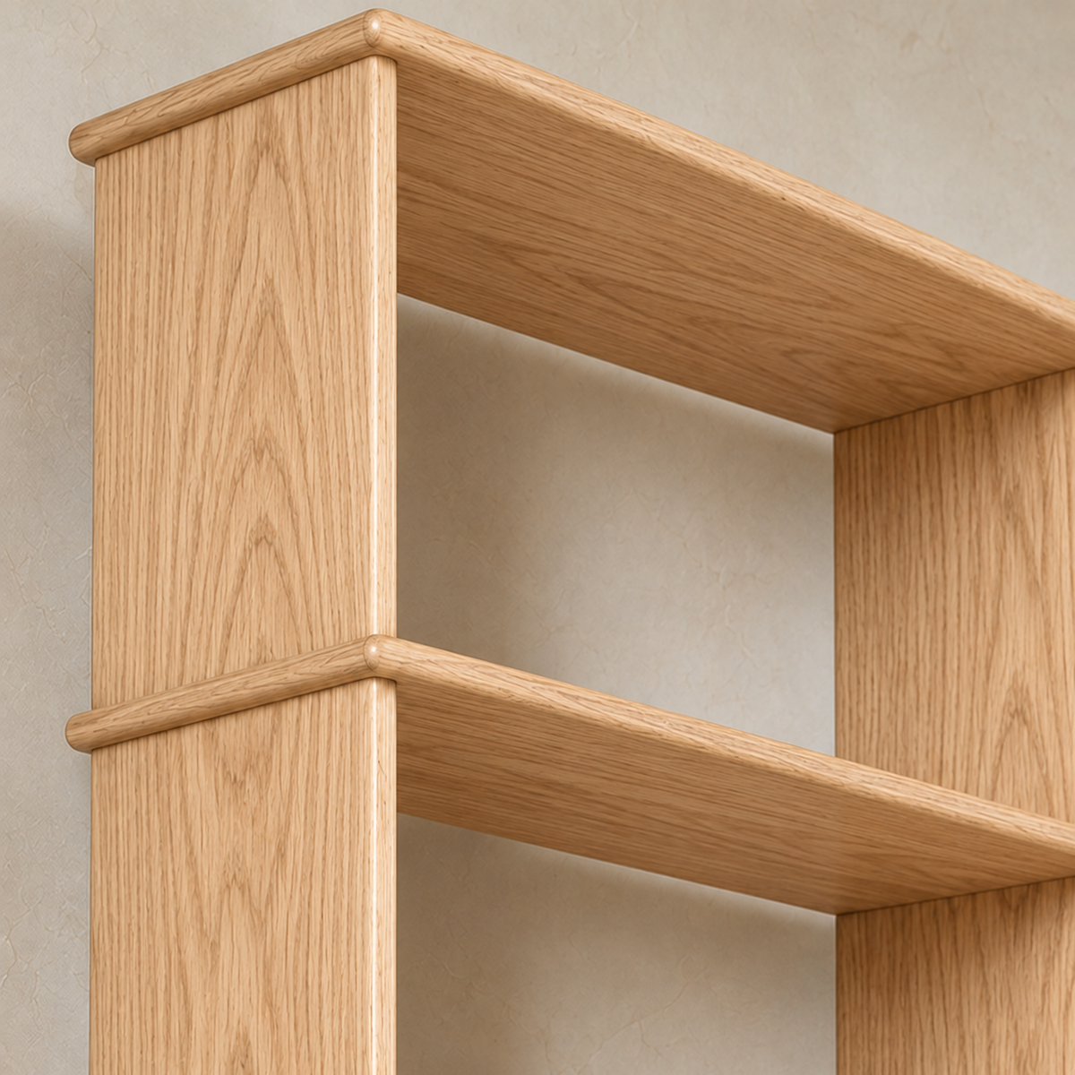 Close-up of a softly rounded shelf edge meeting the side of the 8 foot tall bookcase in white oak.