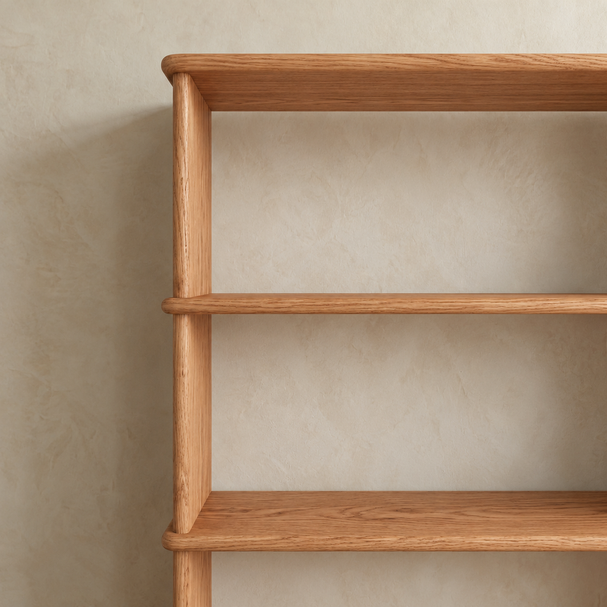 Close-up of the top corner of the red oak bookcase, showing the softly rounded top extending slightly past the side and the oak grain.