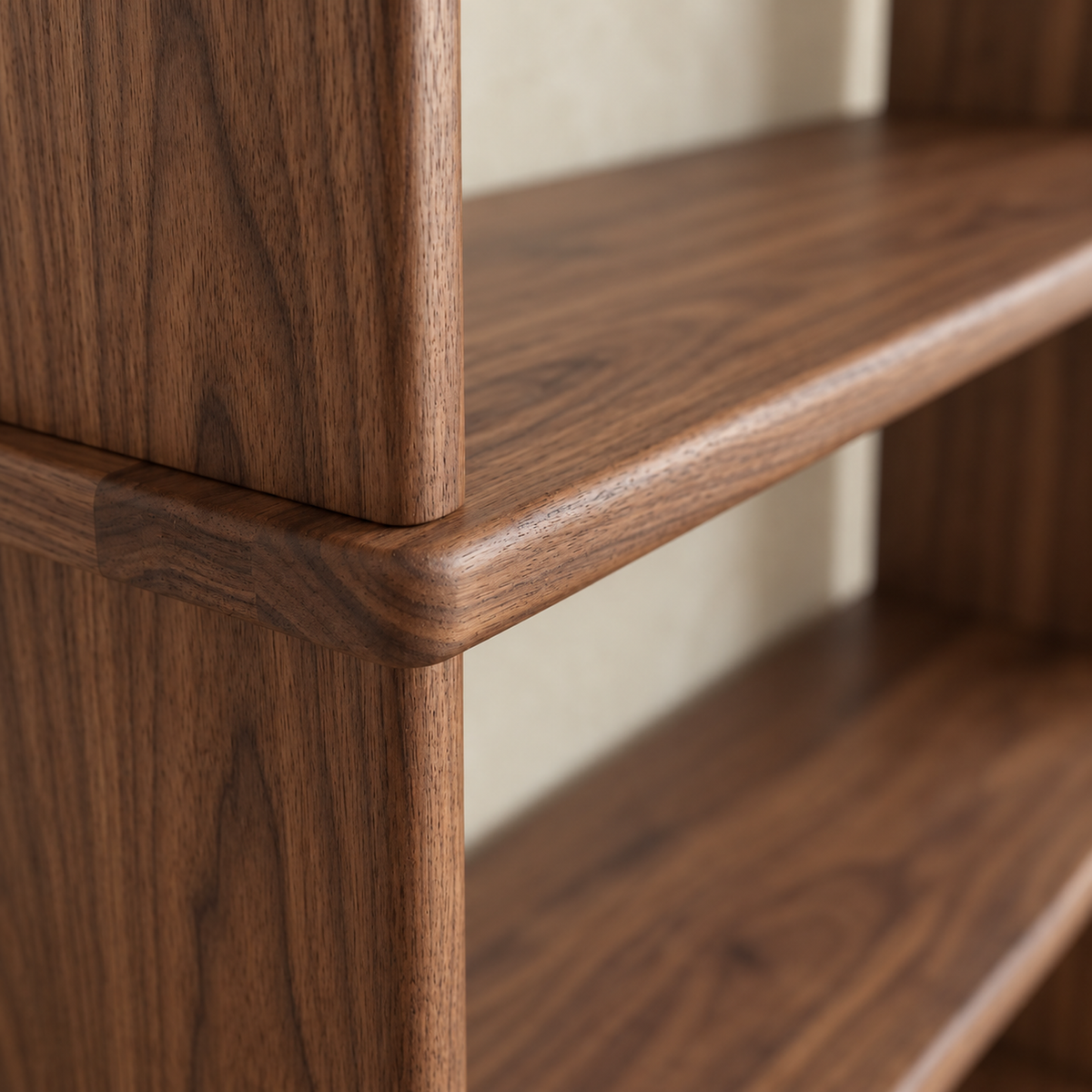Close-up of a front corner of the walnut bookcase, where a shelf's rounded edge meets the solid side.