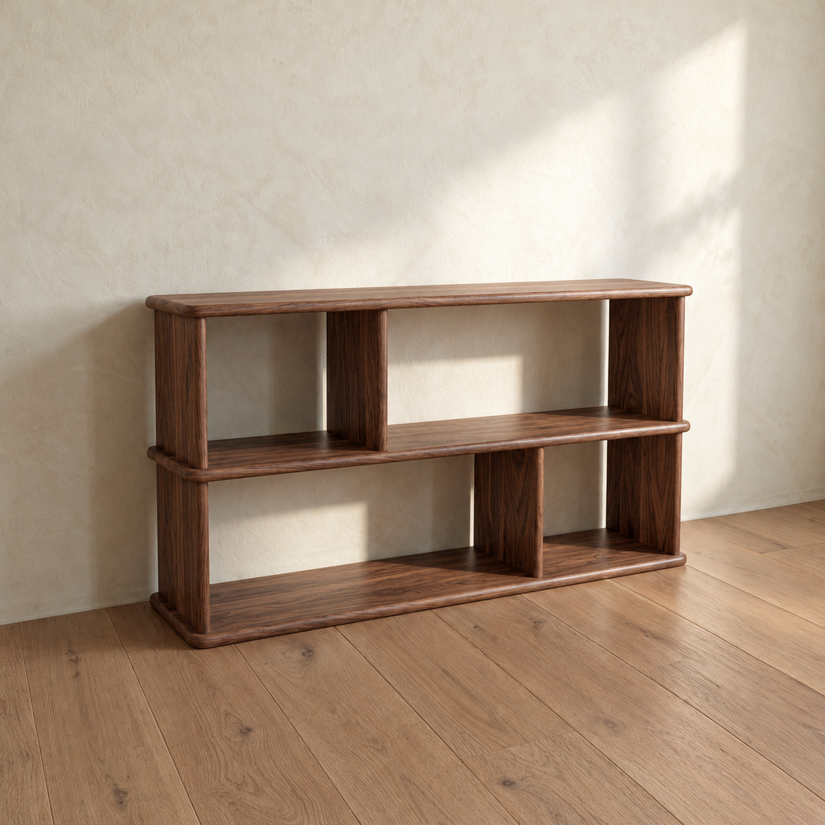 The empty horizontal bookshelf in walnut from an angle, showing the offset dividers and the rounded edges.