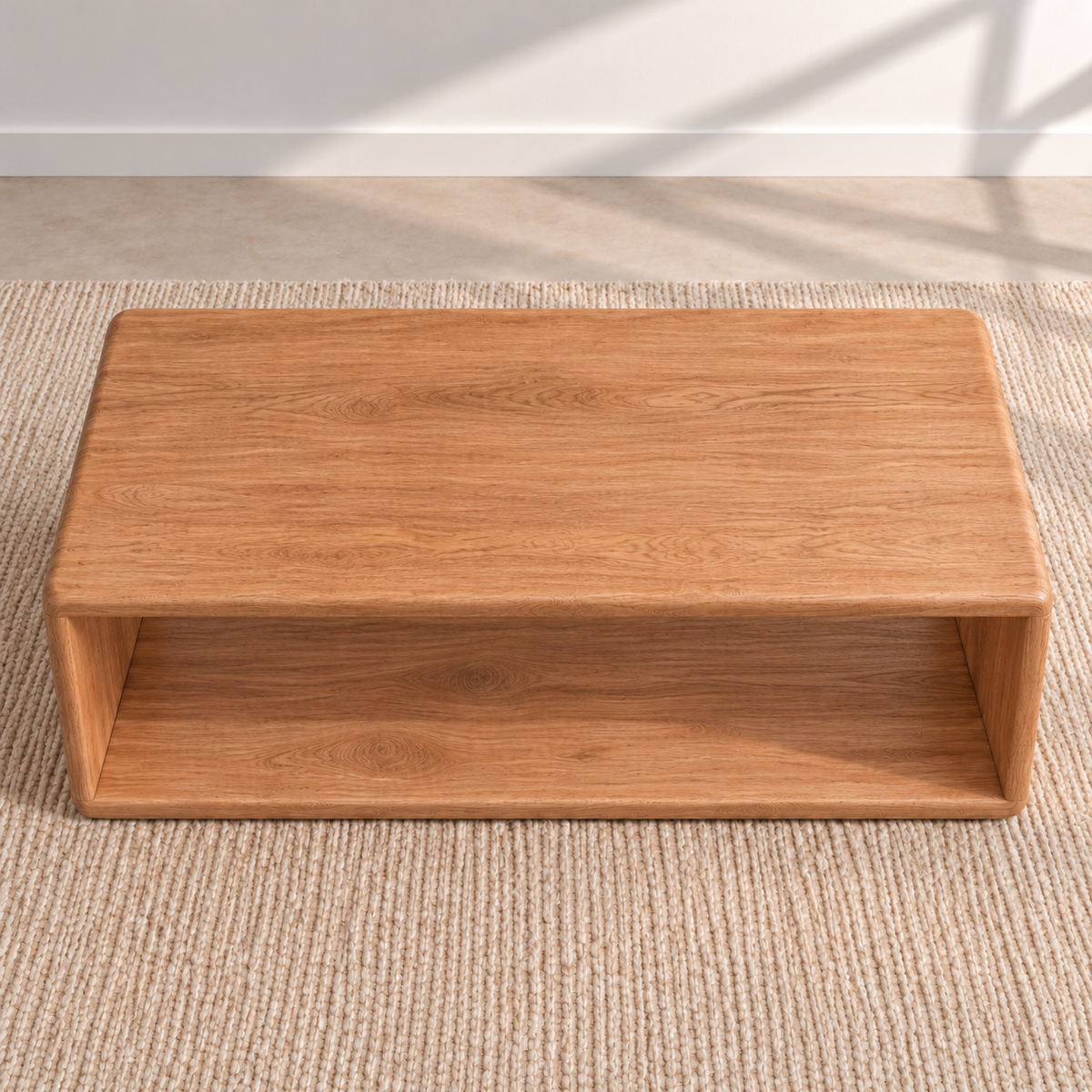 The Japandi coffee table in red oak seen from above, showing the grain of the solid top and the open shelf below it.