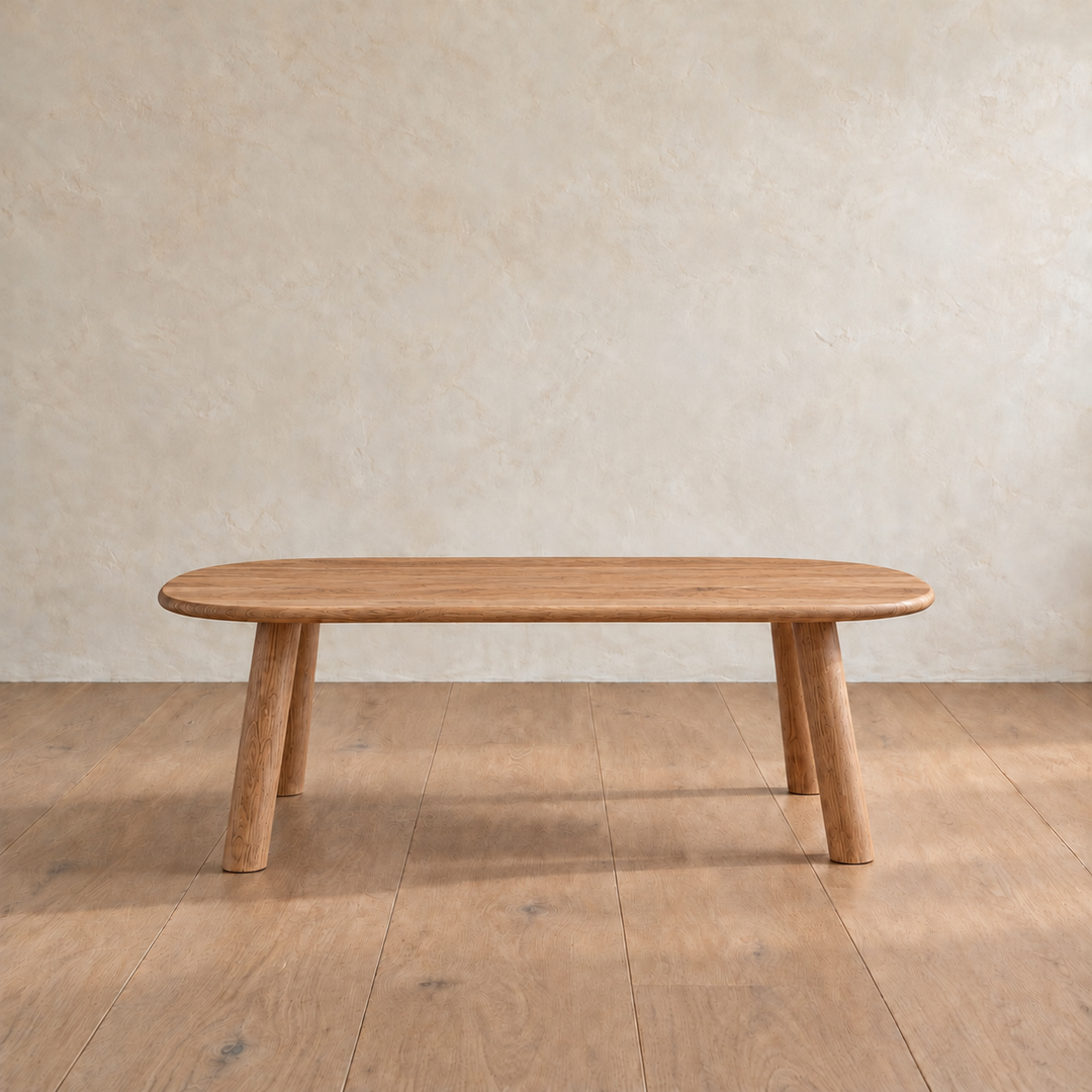 Front view of the minimalist coffee table in red oak, showing the slim top and splayed round legs.