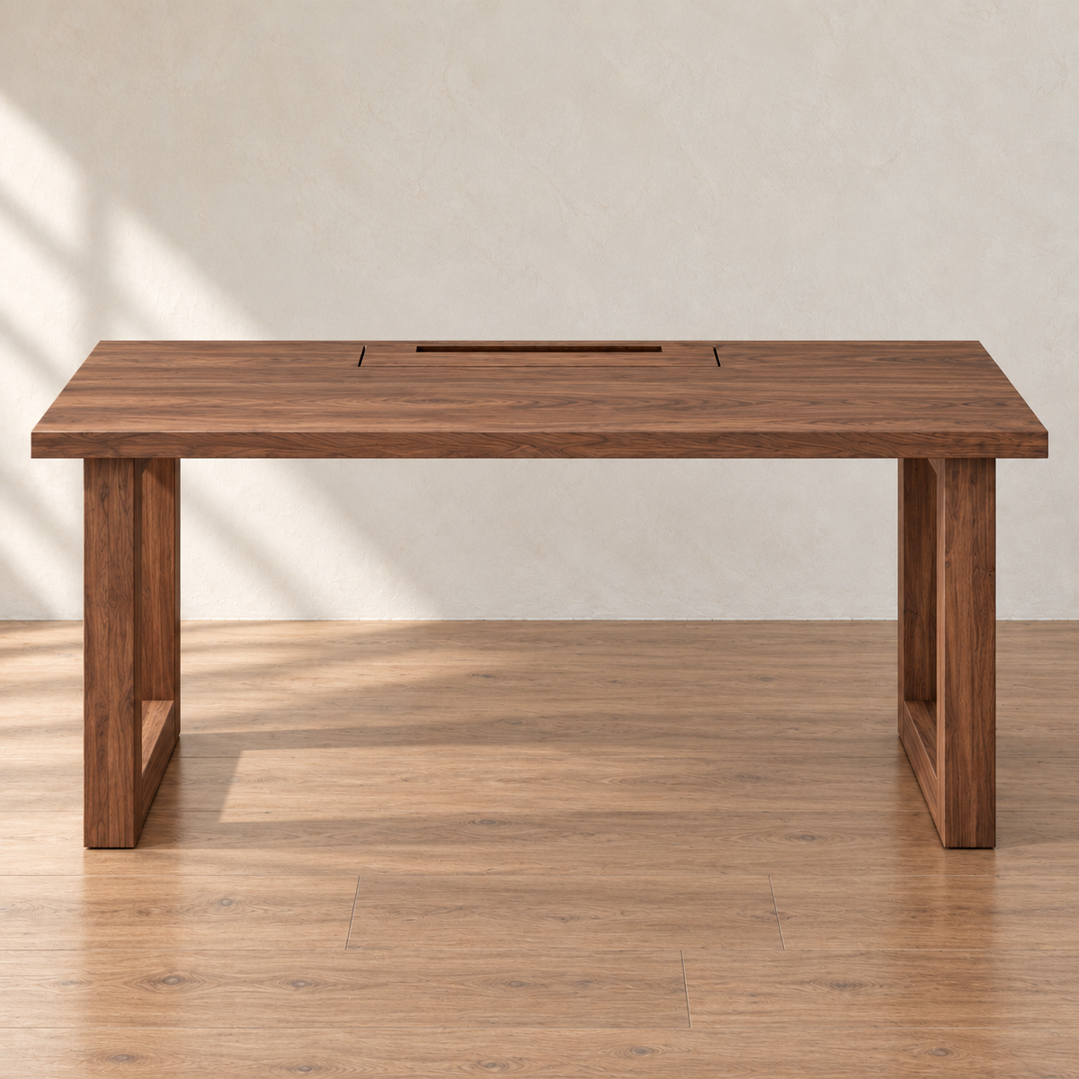 Front view of the minimalist office desk in walnut, with rectangular frame legs and the cable box lid set into the back of the top, in a sunlit room.
