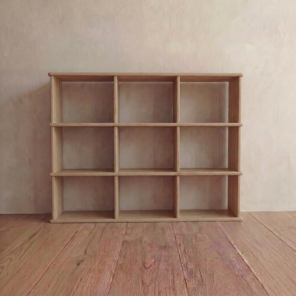 The Nine cube bookshelf in white oak stands empty against a light-colored wall on a wooden floor, bringing Vancouver style to the room.