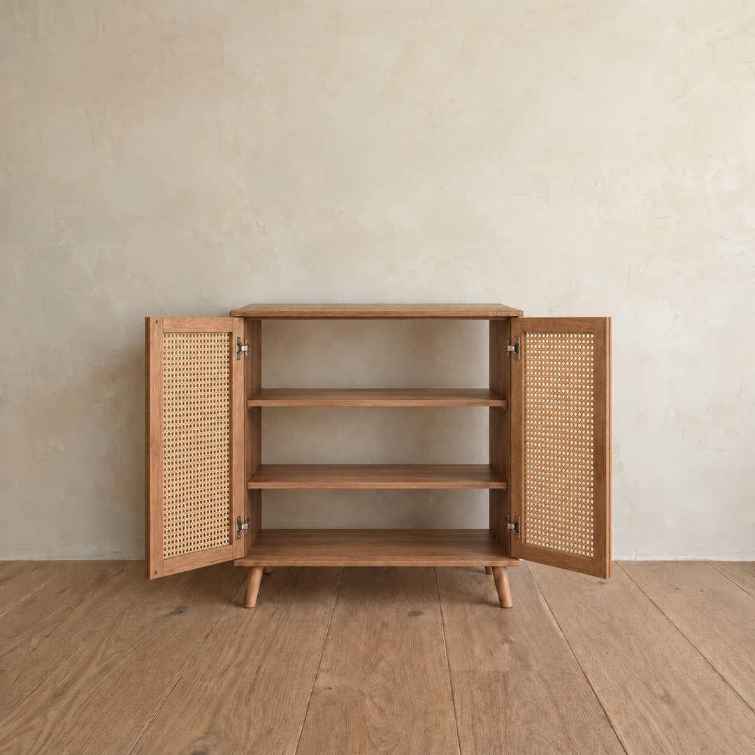 The rattan cabinet in red oak with both doors open, showing two fixed shelves inside.