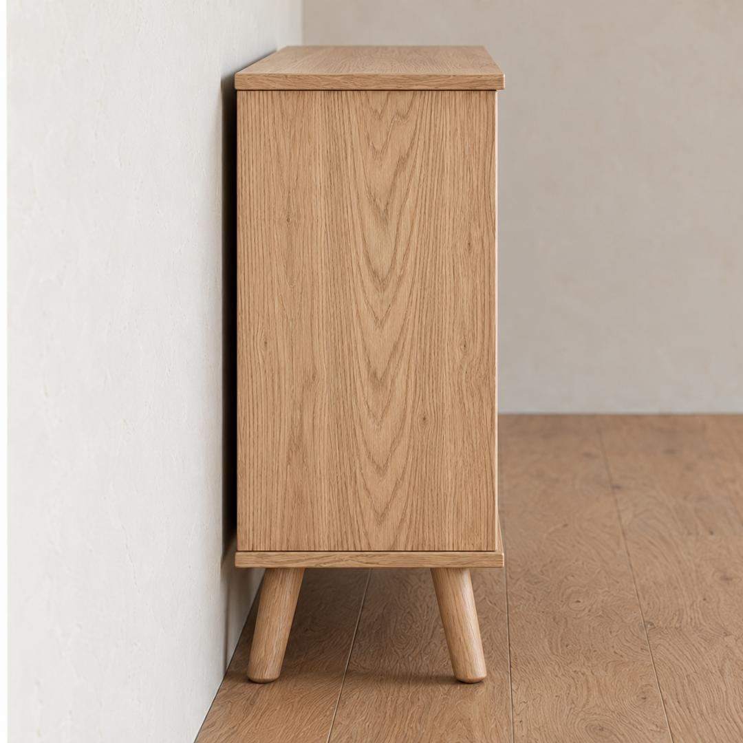 Side view of the rattan cabinet in white oak, showing the solid white oak side panel and splayed tapered legs.