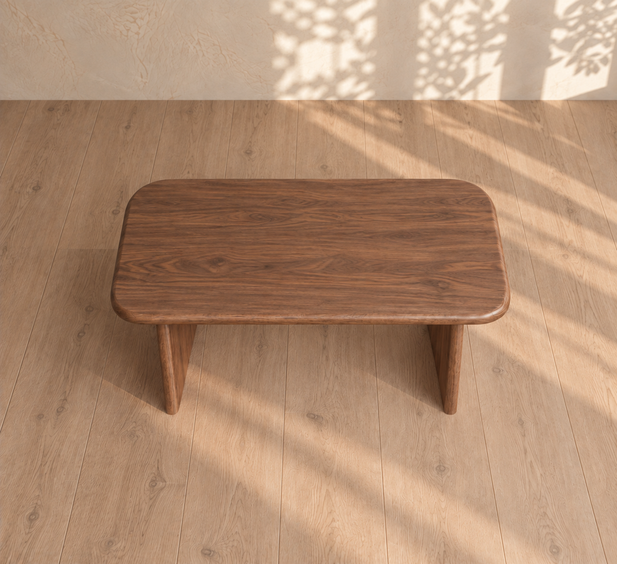 A 40 inch coffee table in walnut, featuring a rectangular handmade design with rounded edges, rests on a light wood floor. Sunlight floods its solid walnut surface and sides, while dappled leaf shadows dance across the wall and floor—adding warmth and elegance to your living space.