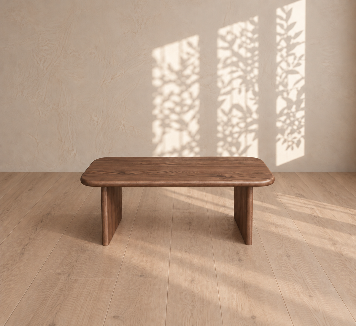 A 40 inch coffee table in walnut sits on a light wood floor with tree branch shadows cast on the beige wall behind it.