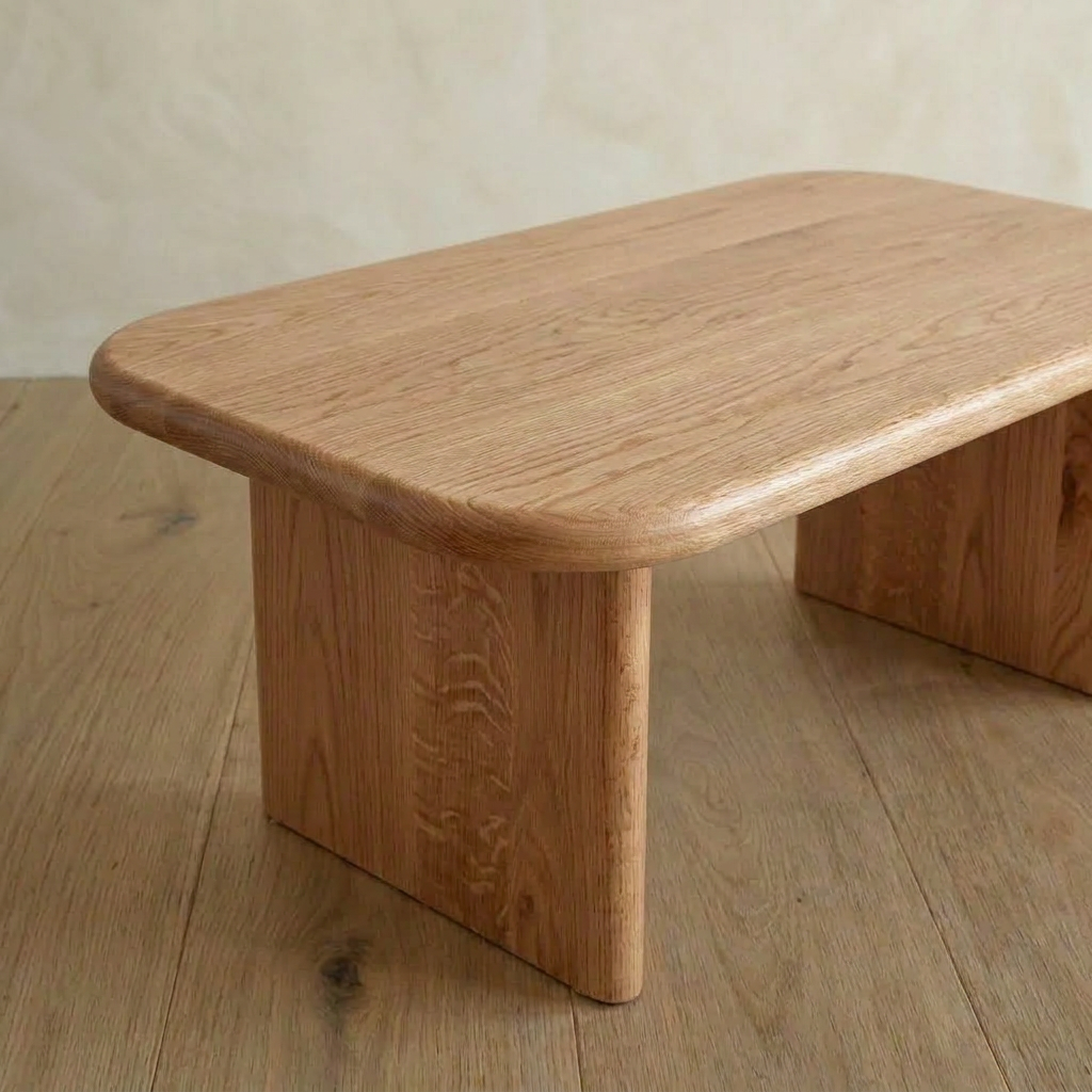 A 40 inch coffee table in red oak with a handmade rectangular design, rounded edges, and sturdy legs stands on a wooden floor against a plain light-colored wall.