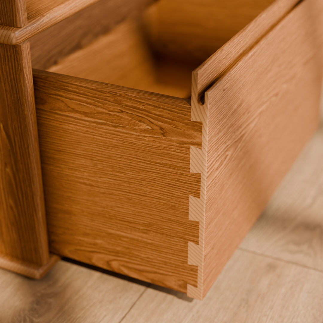 Close-up of the dovetail joints at the front corner of the red oak nightstand drawer.