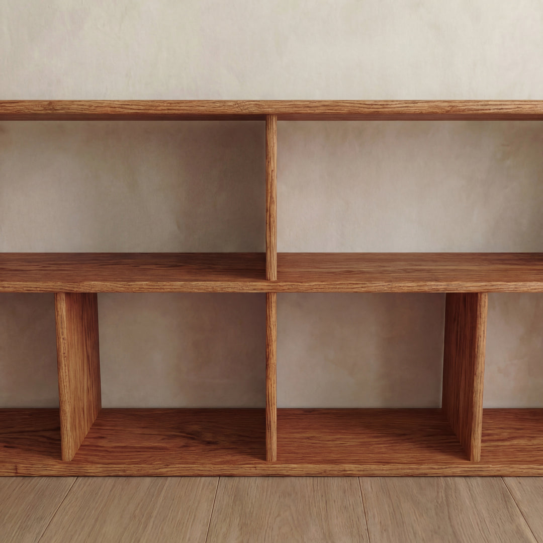 A 65 inch bookshelf TV stand in red oak with six empty rectangular compartments stands against a light-colored wall on a wooden floor.