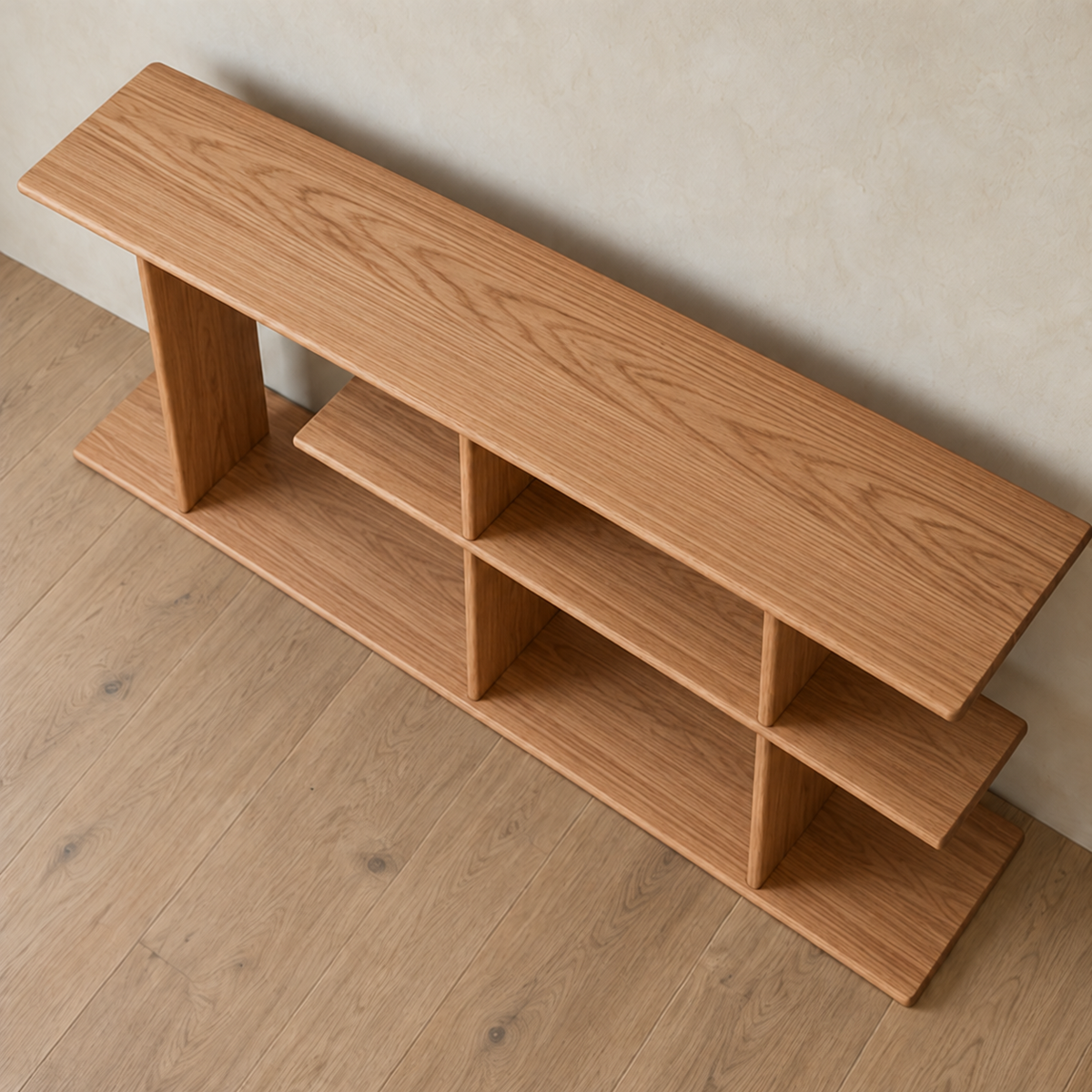 The staggered shelf bookcase in red oak seen from above, showing the long top board and the offset middle shelf.