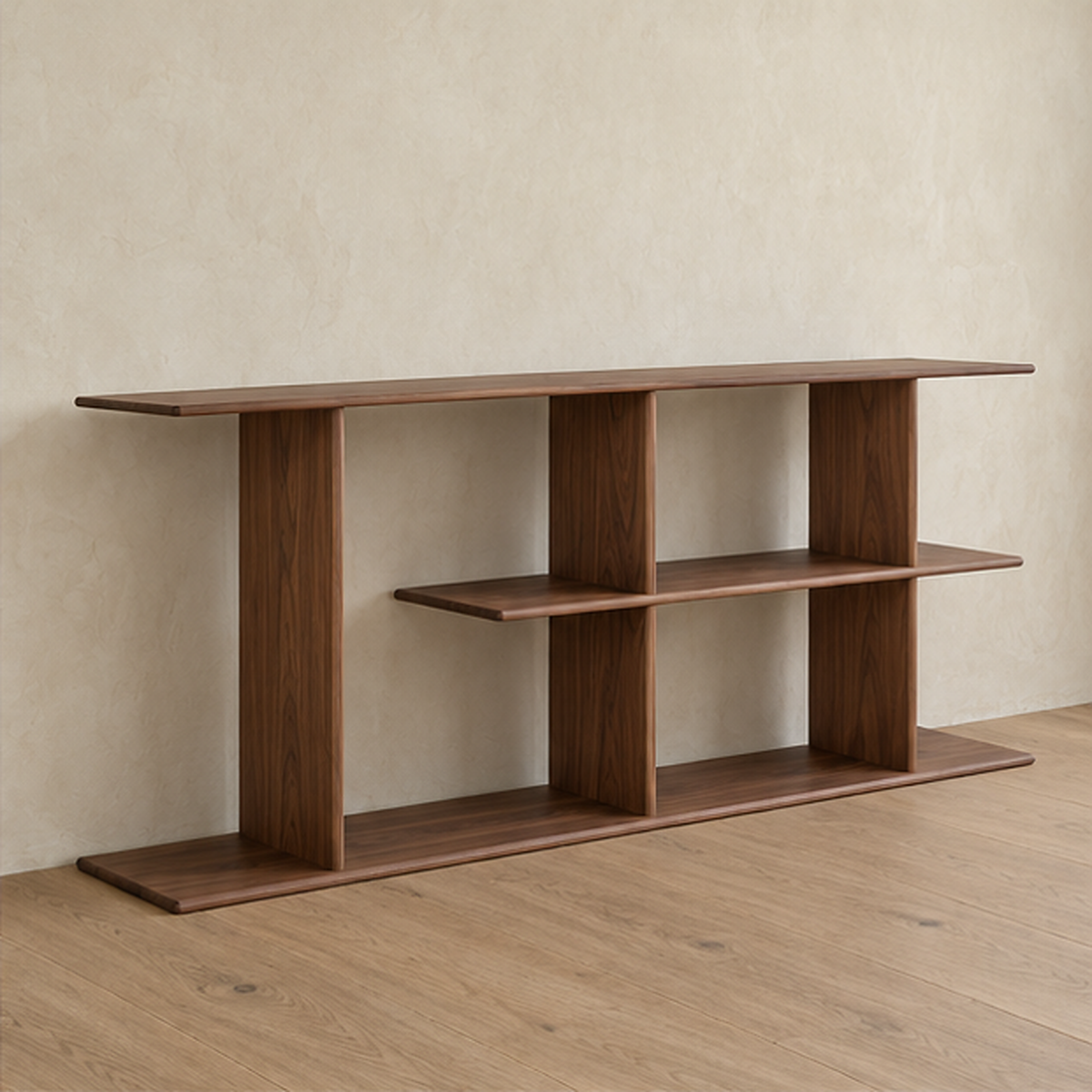 The staggered shelf bookcase in walnut from an angle against a plaster wall.