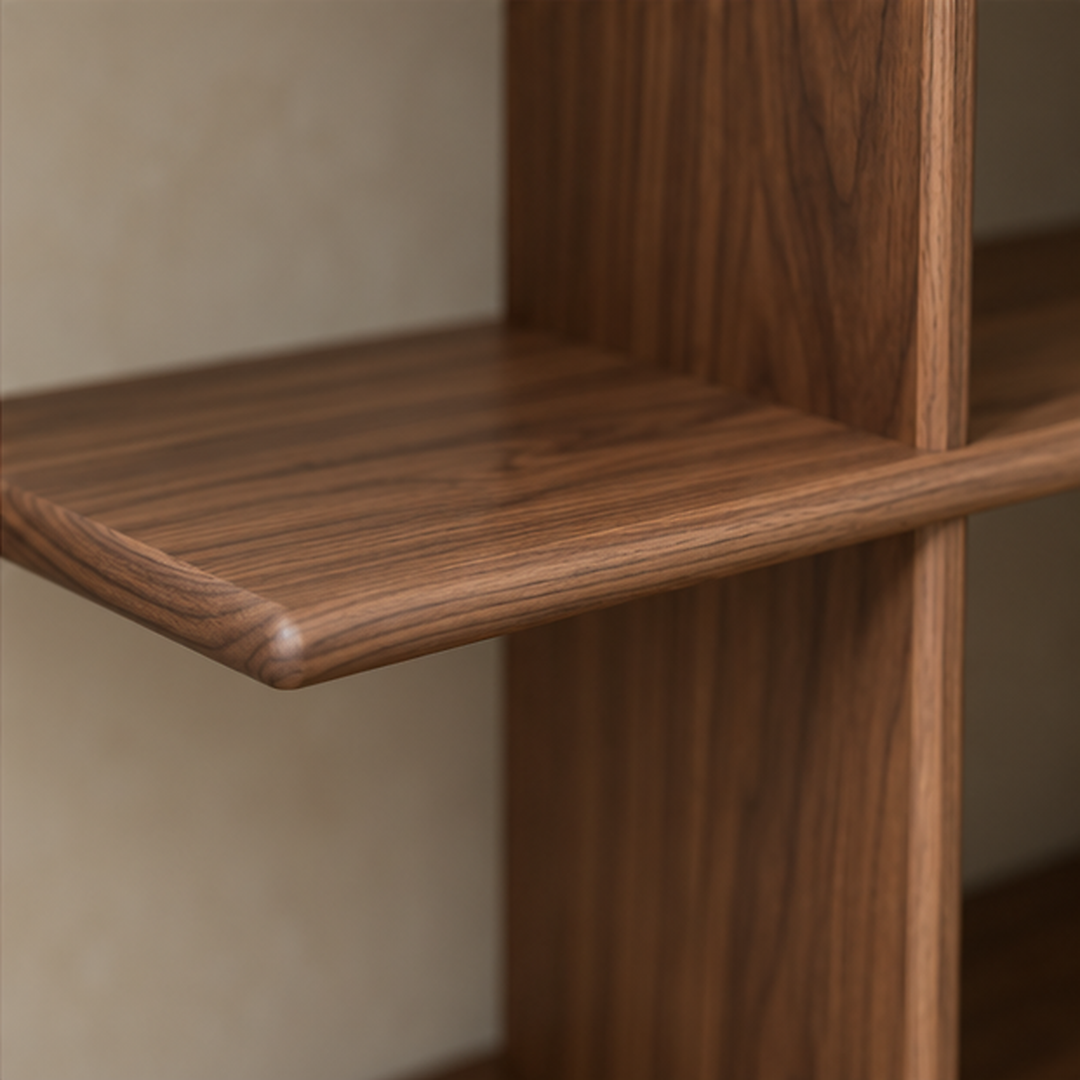 Close-up of the softly rounded corner of the middle shelf where it meets an upright, in walnut.