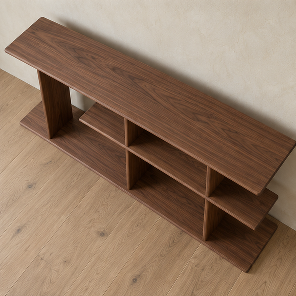 The staggered shelf bookcase in walnut seen from above, showing the long top board and the offset middle shelf.