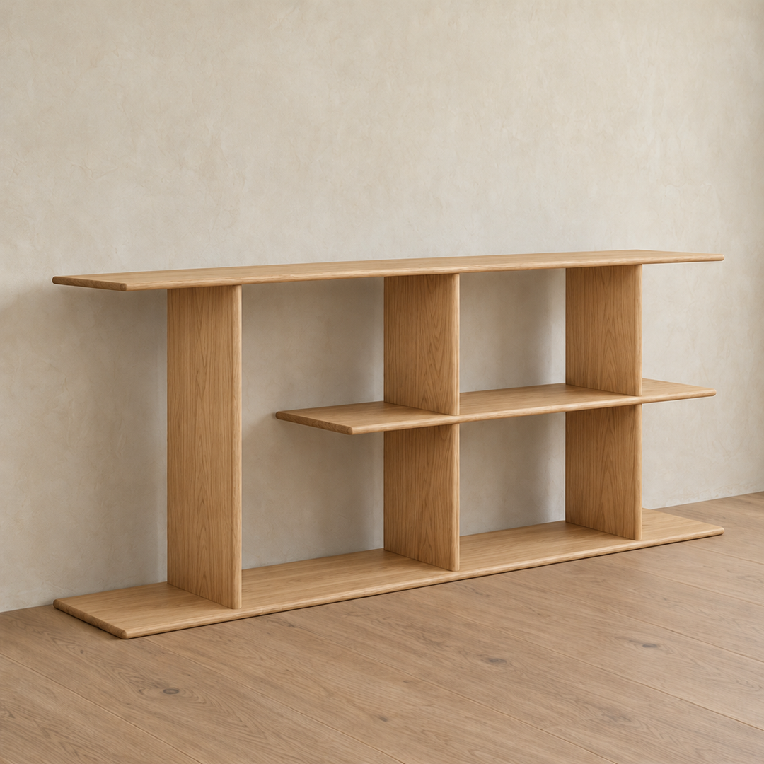 The staggered shelf bookcase in white oak from an angle against a plaster wall.