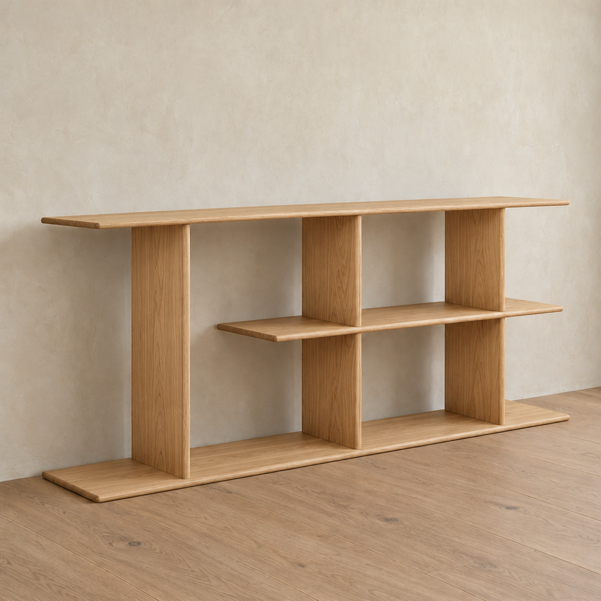 The staggered shelf bookcase in white oak from an angle against a plaster wall.