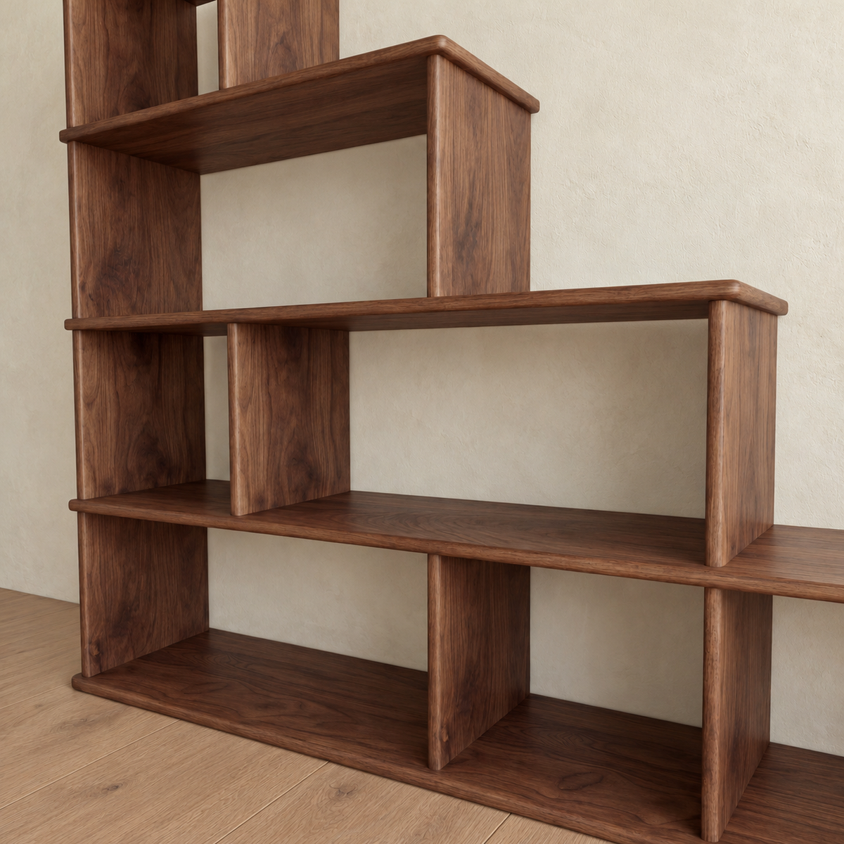 A low, angled close-up of the step bookshelf in walnut, looking along the stepped shelves and open cubes.