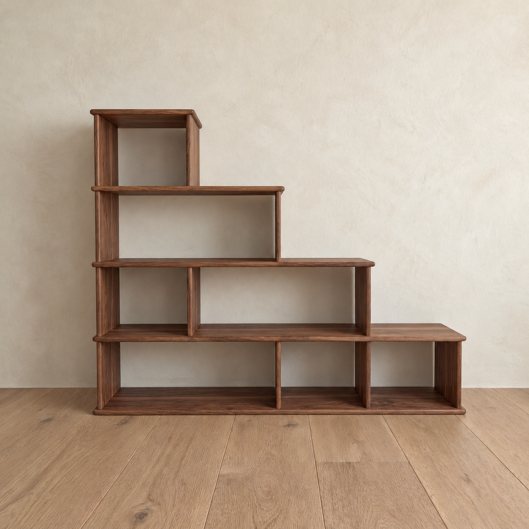 Front view of the empty step bookshelf in walnut, with open cubes stepping down from four tiers on the left to one on the right.
