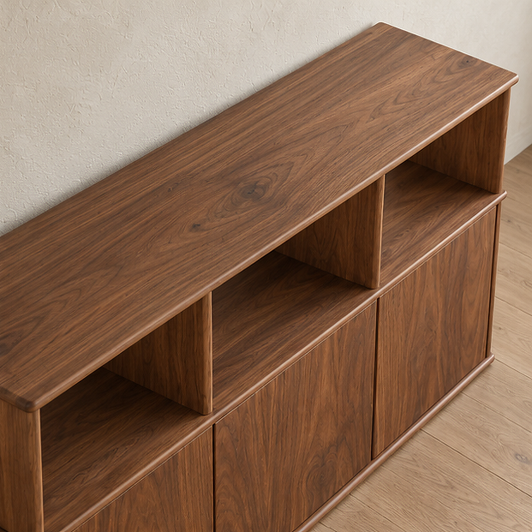 The three door sideboard in walnut seen from above, showing the grain of the solid top and the open cubbies below it.