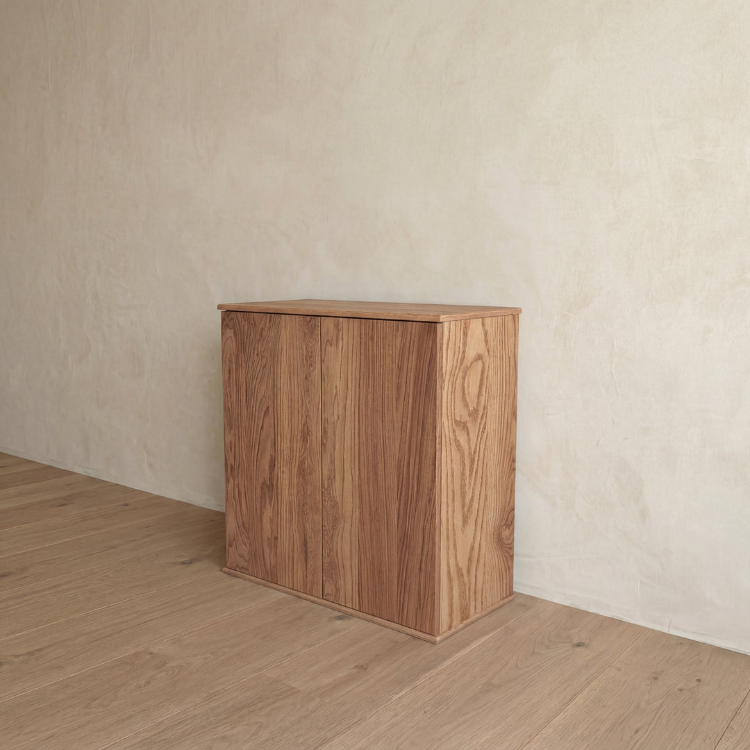 Two door cabinet in red oak — angled view