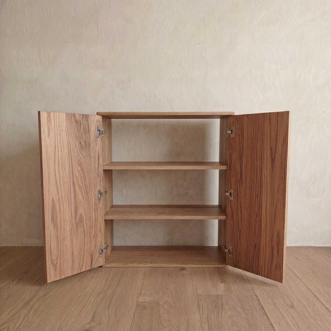 Two door cabinet in red oak — doors open