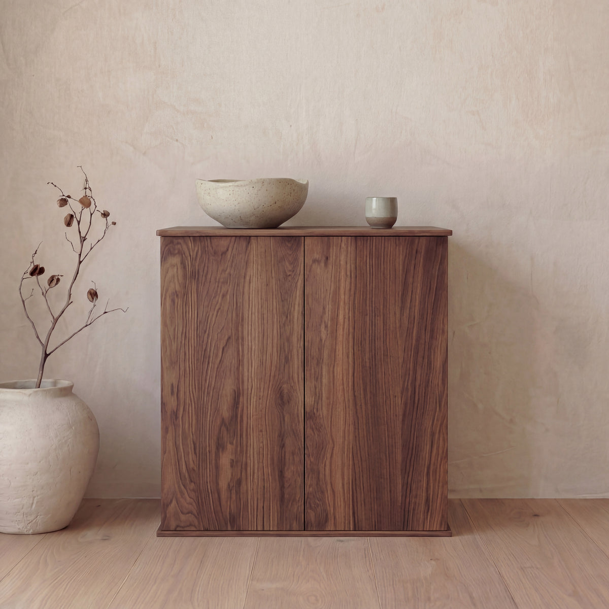 Two door cabinet in walnut — with decor