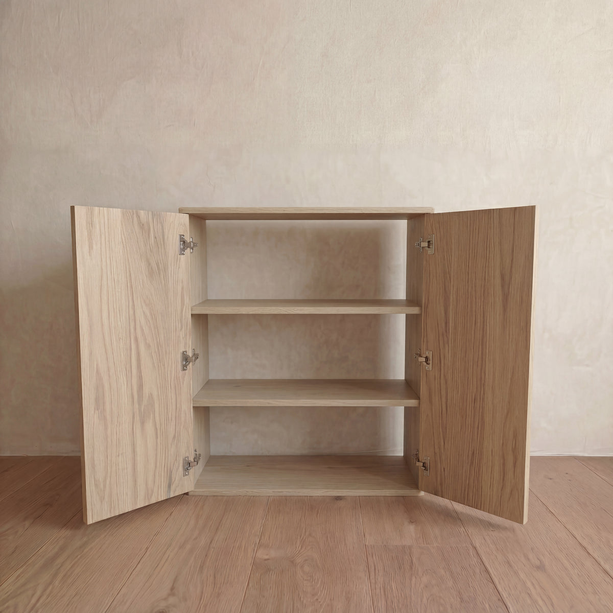 Two door cabinet in white oak — doors open